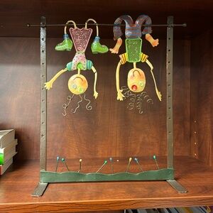 Whimsical metal sculpture of kids hanging upside down!